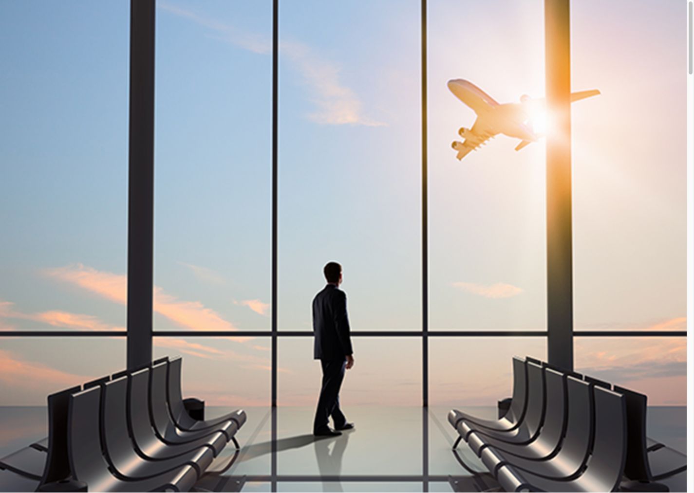 Aviation professional looking toward an aircraft from an airport terminal